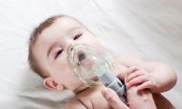 Doctor makes inhalation so a sick baby